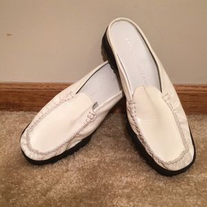 Antonio Melani white leather mules.